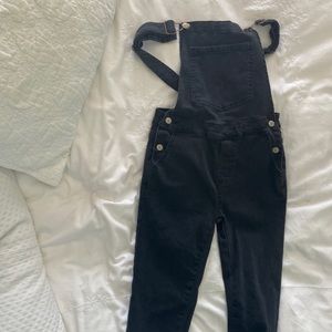 Size 12. Black overalls with red stars.
